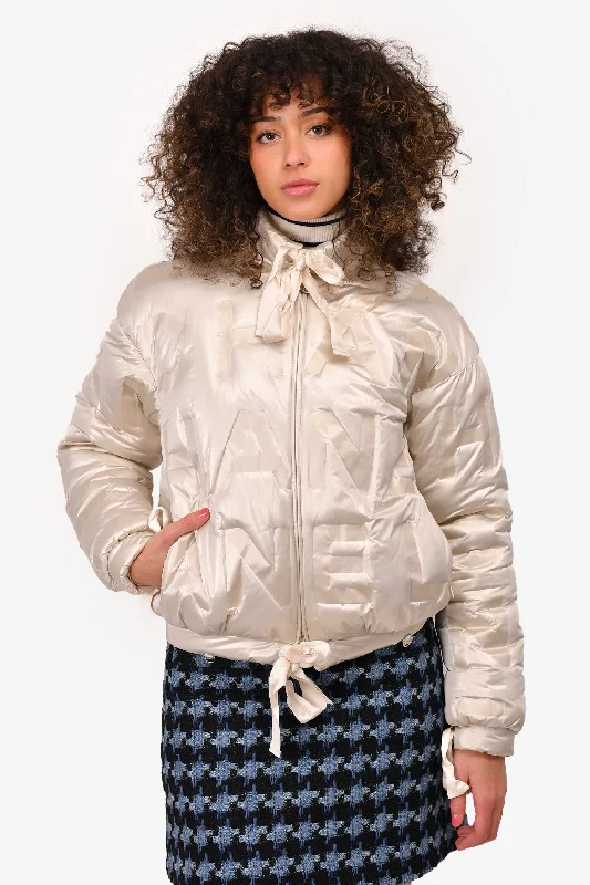 Don't Miss Out – Your Favorite Fashion Pieces On Sale Pre-Loved Chanel™ 2018 Cream Reflective Metallic Logo Printed Down Jacket Size 34 (As Is)